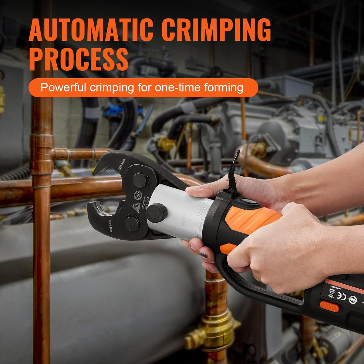 Electric pipe crimping tool being used on a copper pipe connection in a plumbing work area